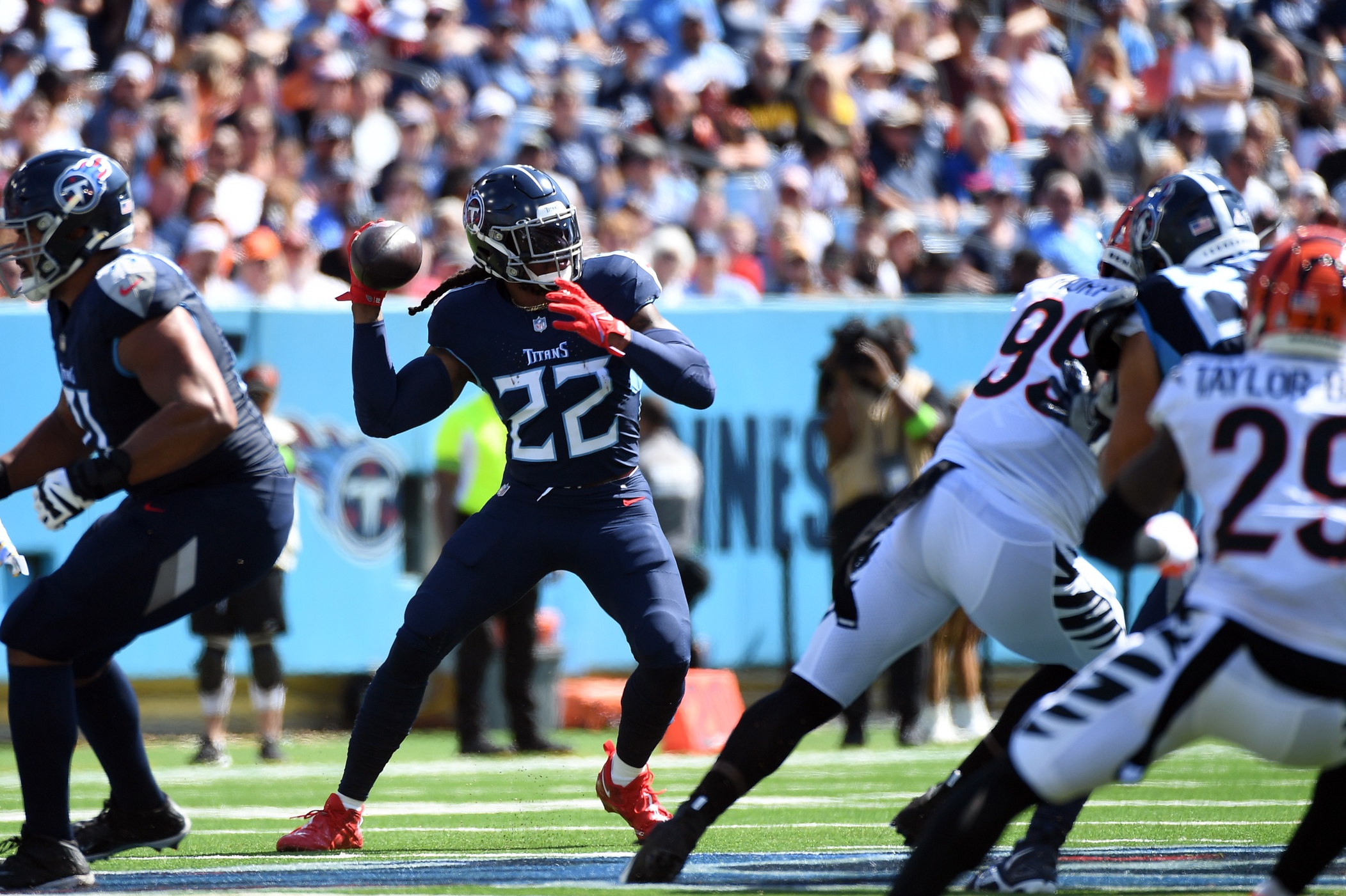 Derrick Henry (22) throws the ball back to quarterback Ryan Tannehill (not pictured) on a play during the first half against the Cincinnati Bengals at Nissan Stadium. 